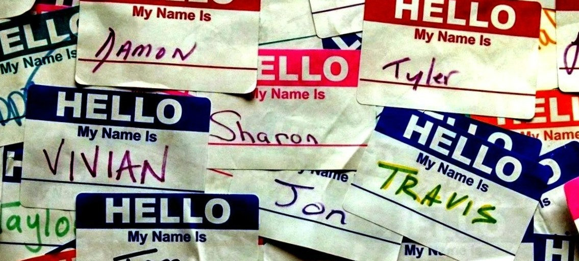 A collection of "Hello My Name Is" nametag stickers, with different names written in, like Vivian, Tom, Jen, and Tyler.