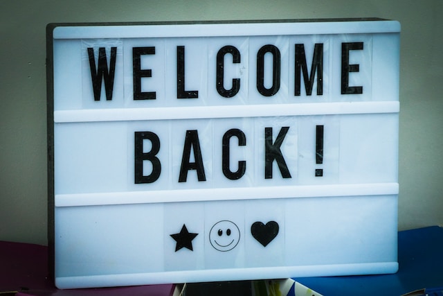 white sign that says, "Welcome Back!"