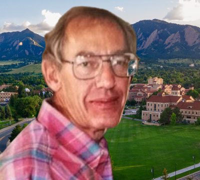 The late David Huizinga in a pink checkered shirt and glasses. Behind, an aerial view of CU Boulder campus.