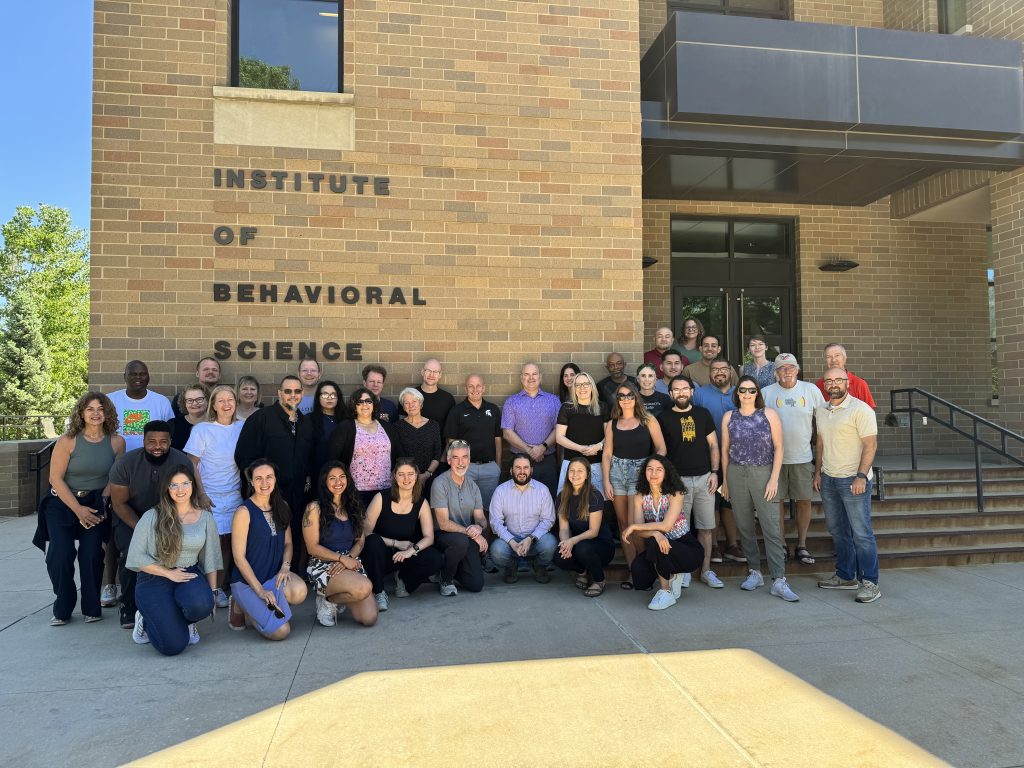 Outside of the Richard Jessor Building, participants of the Eurogang conference pose for a photo. 