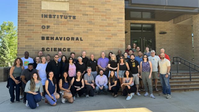 Outside of the Richard Jessor Building, participants of the Eurogang conference pose for a photo.