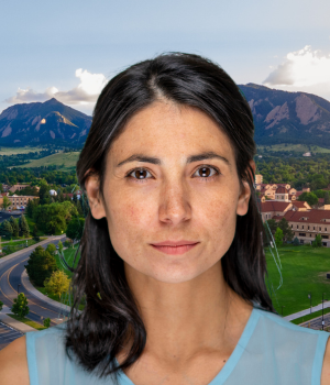 Jamie Haverkamp wears a light blue top. In the background, the CU Boulder campus with the Boudler Flatirons.