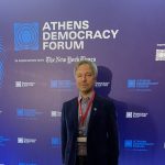 Kacper Gradon stands at the Athens Democracy Forum. Gradon is a visiting IBS scholar and associate professor of both security and crime science at the University College London (UCL) and cybersecurity at Warsaw University of Technology