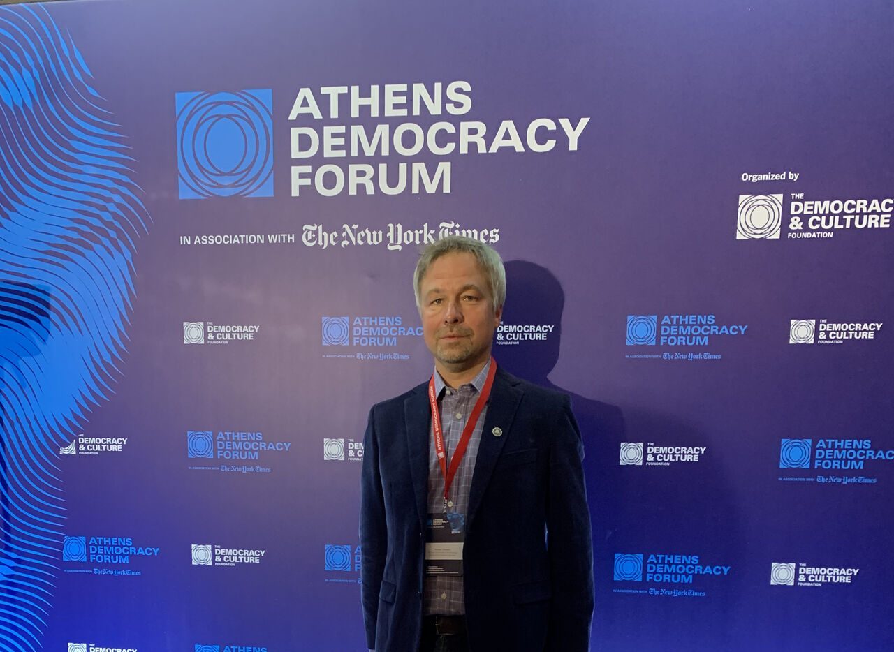 Kacper Gradon stands at the Athens Democracy Forum. Gradon is a visiting IBS scholar and associate professor of both security and crime science at the University College London (UCL) and cybersecurity at Warsaw University of Technology