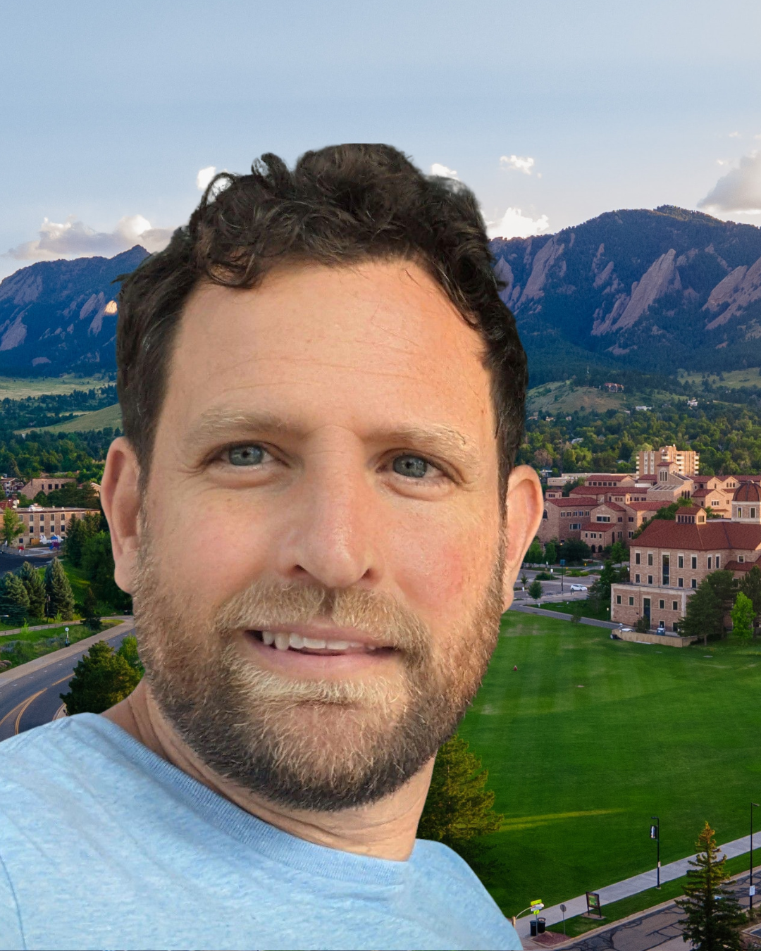 David Ciplet smiling in front of CU Boulder backdrop