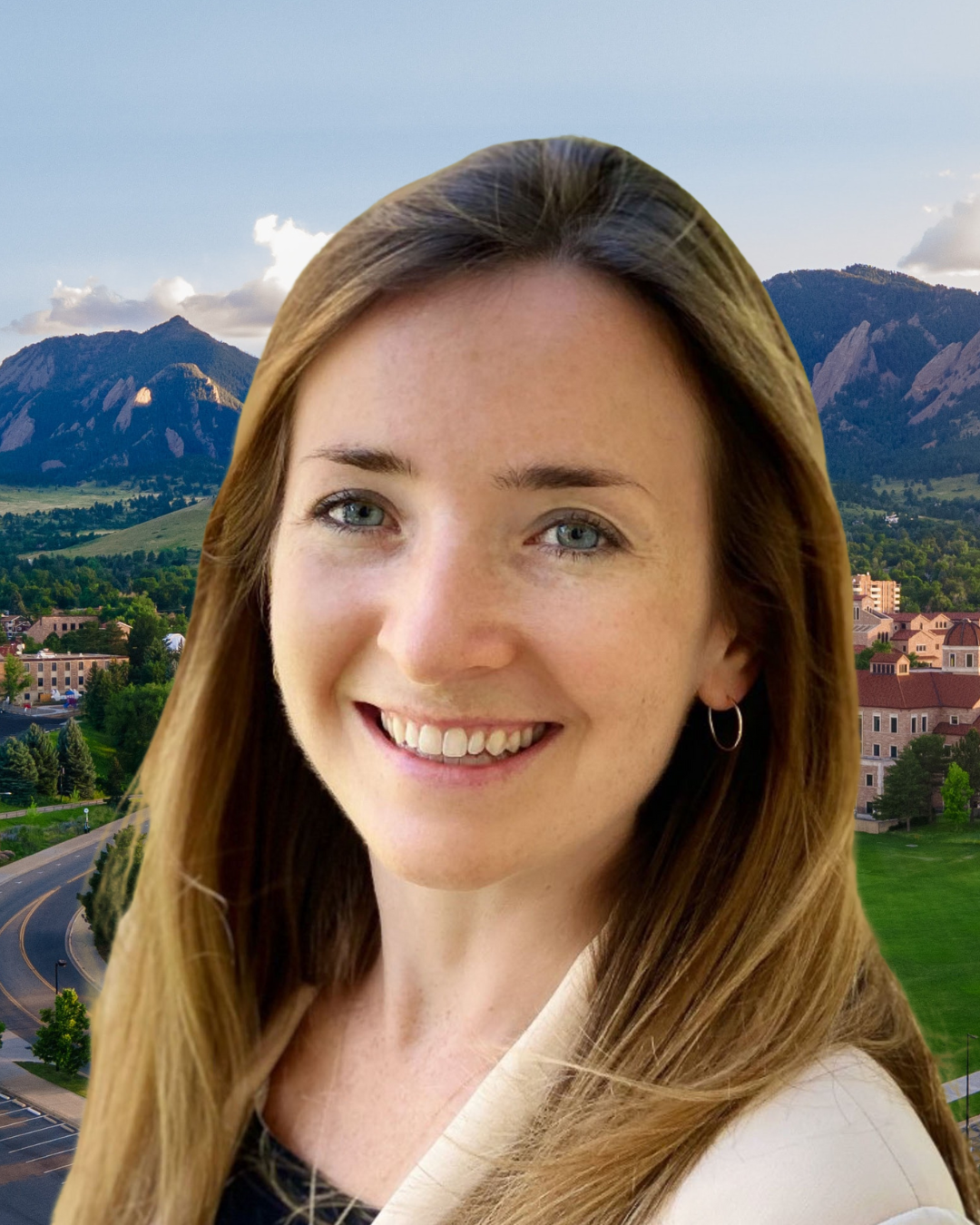 Emily Parker wears a black blouse and tan blazer. Behind her, a view of the Boulder Flatirons.