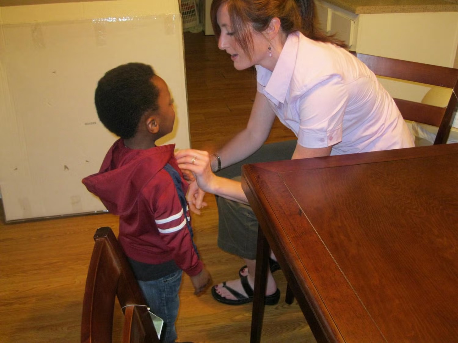 Lori Peek, a CU Boulder professor of sociology and director of the Natural Hazards Center, conducts fieldwork with a child after Hurricane Katrina; the child was later affected by the BP Deepwater Horizon oil spill as well.