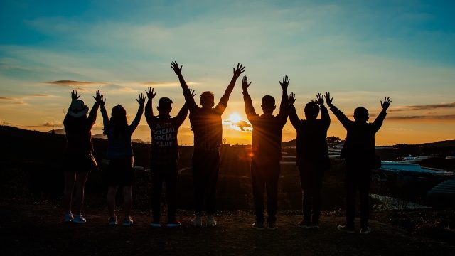 Teenagers join hands while watching the sunset in a Colorado suburb.