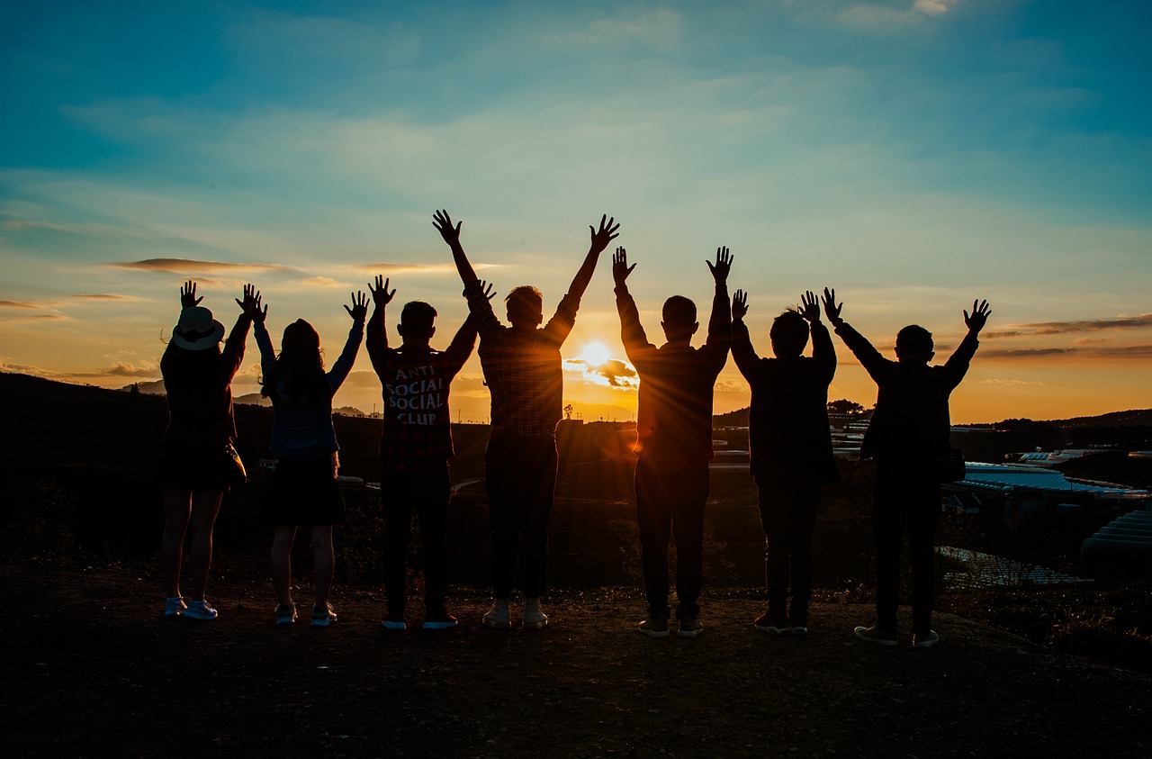 Teenagers join hands while watching the sunset in a Colorado suburb.