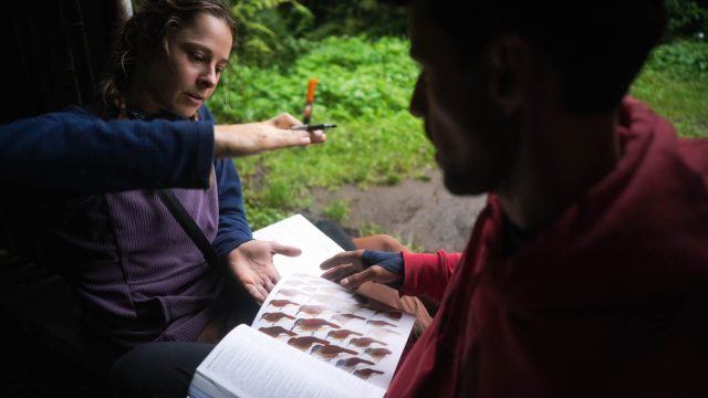 Savannah Lehnert talks with a local in the Amazon about agroforestry methods.