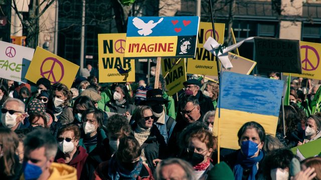 A group of protesters picket for the Russia - Ukrainee war.